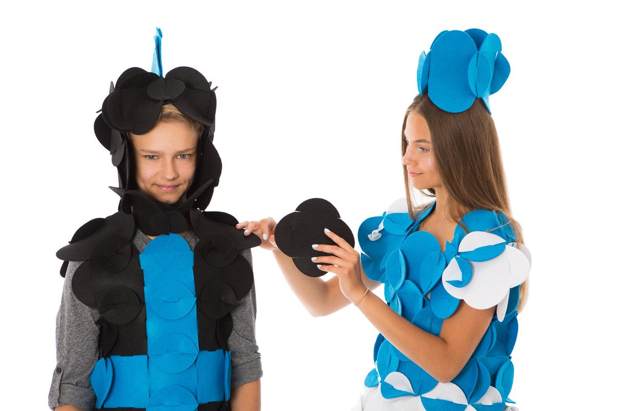 6. Two children assembling Sir William the Brave Knight costume with blue and black felt pieces