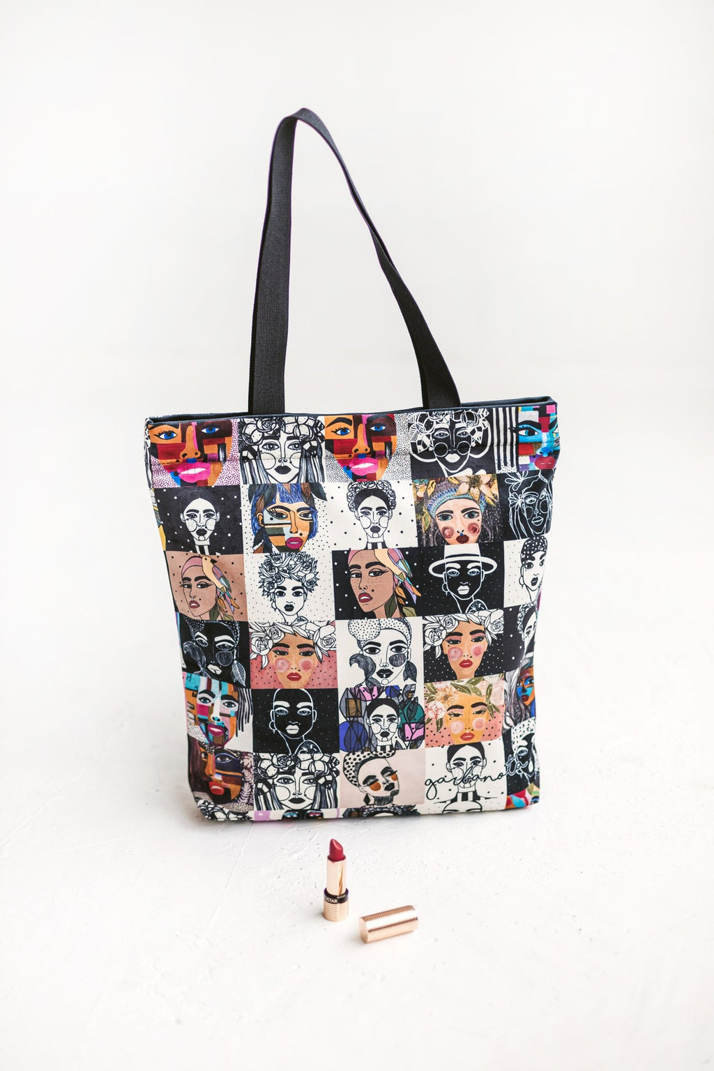 4. Close-up of Garbanota handbag mosaic colored with graphic paintings, shown with lipstick for scale