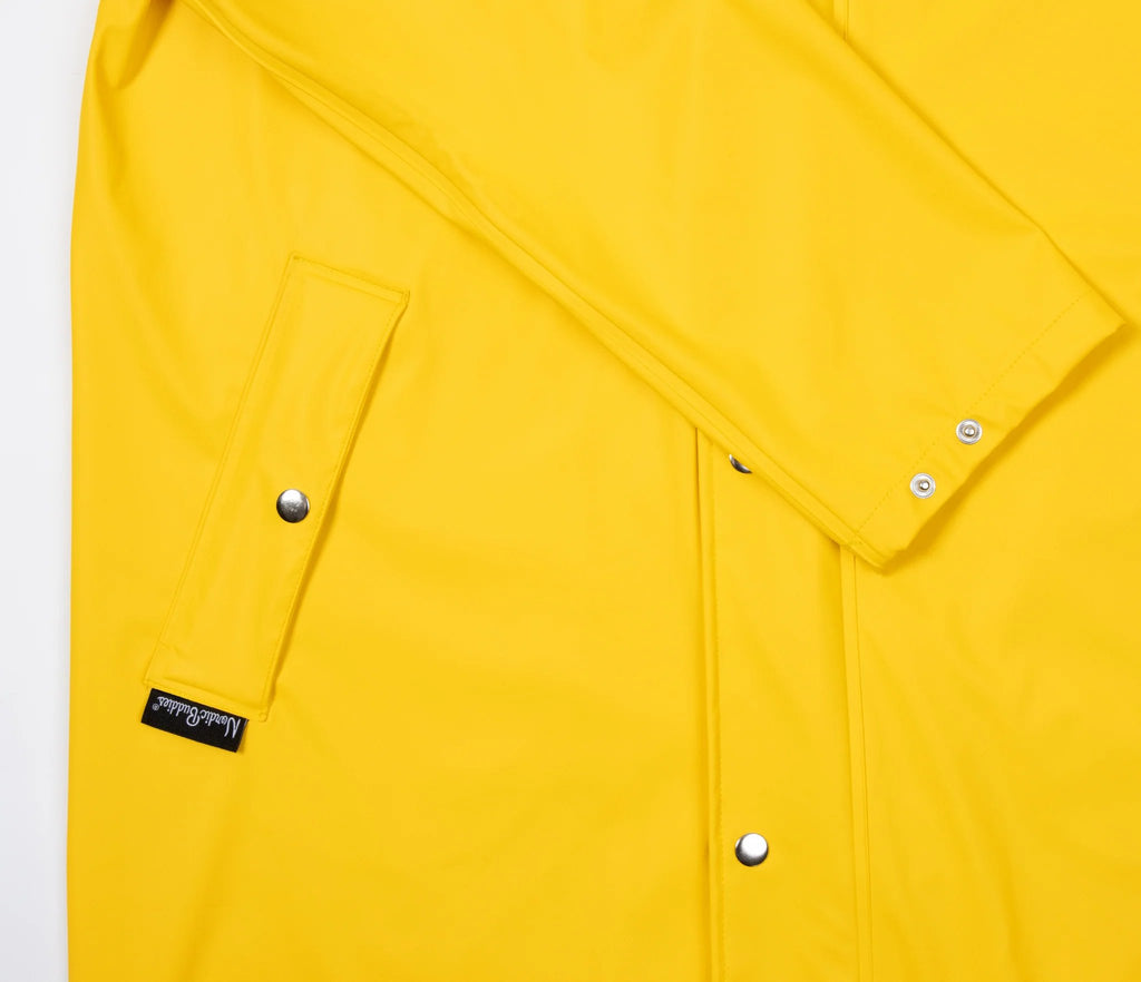 13. Close-up of buttoned pocket on yellow Moomin Adventure Rain Jacket