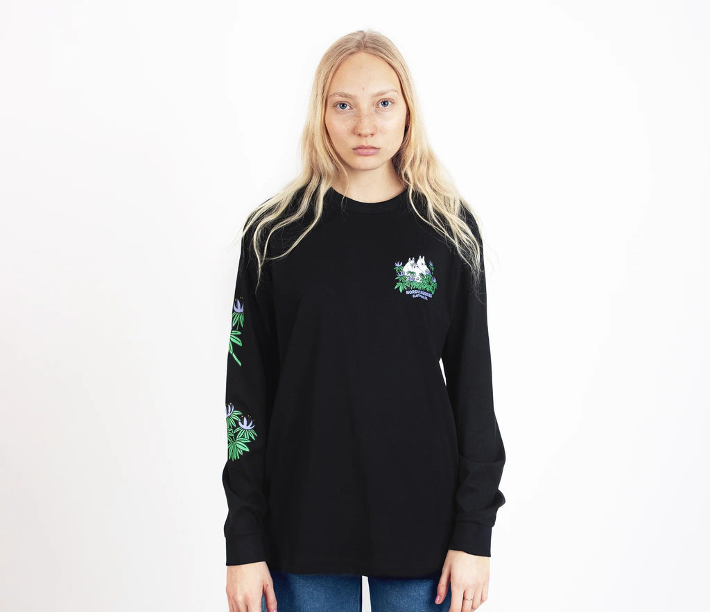 7. Female model wearing Moomin by NordicBuddies black longsleeve shirt with cuffrib, front view in studio