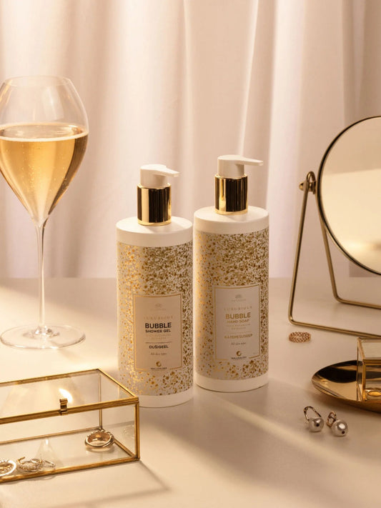 2. Magrada Organic Cosmetics Bubble Shower Gel bottles on elegant vanity with sparkling wine, highlighting luxurious aroma