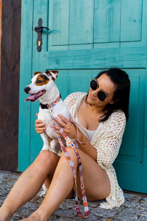 4. Woman sitting with small dog wearing Matteo Boho Collection collar in front of turquoise door