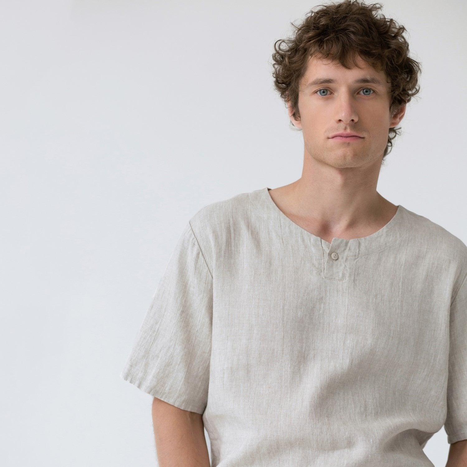 3. Close-up of man wearing beige linen pyjama top with button fastening, shown in studio setting