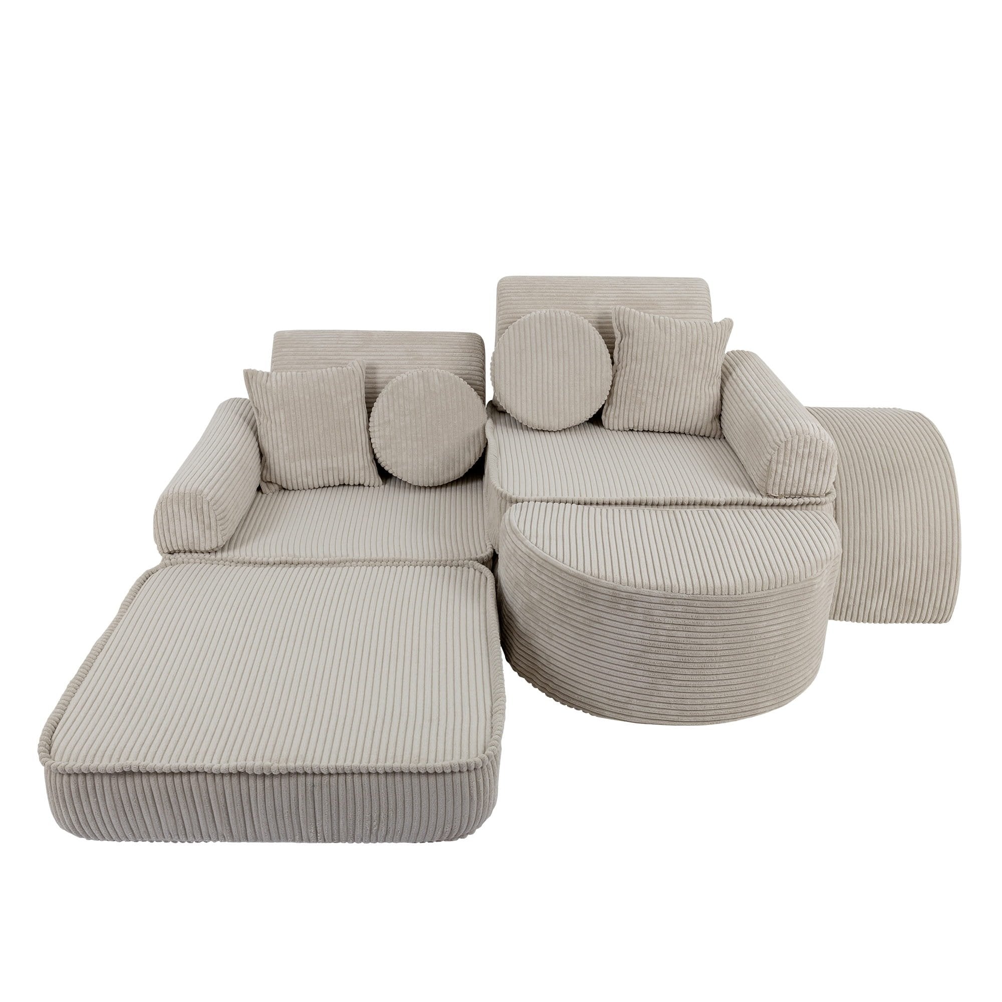 3. Children's modular sofa in ecru with ribbed texture, arranged in a creative layout with cushions, shown in a studio setting.