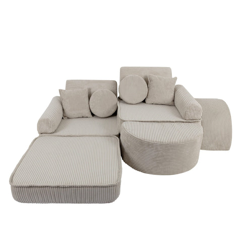 3. Children's modular sofa in ecru with ribbed texture, arranged in a creative layout with cushions, shown in a studio setting.