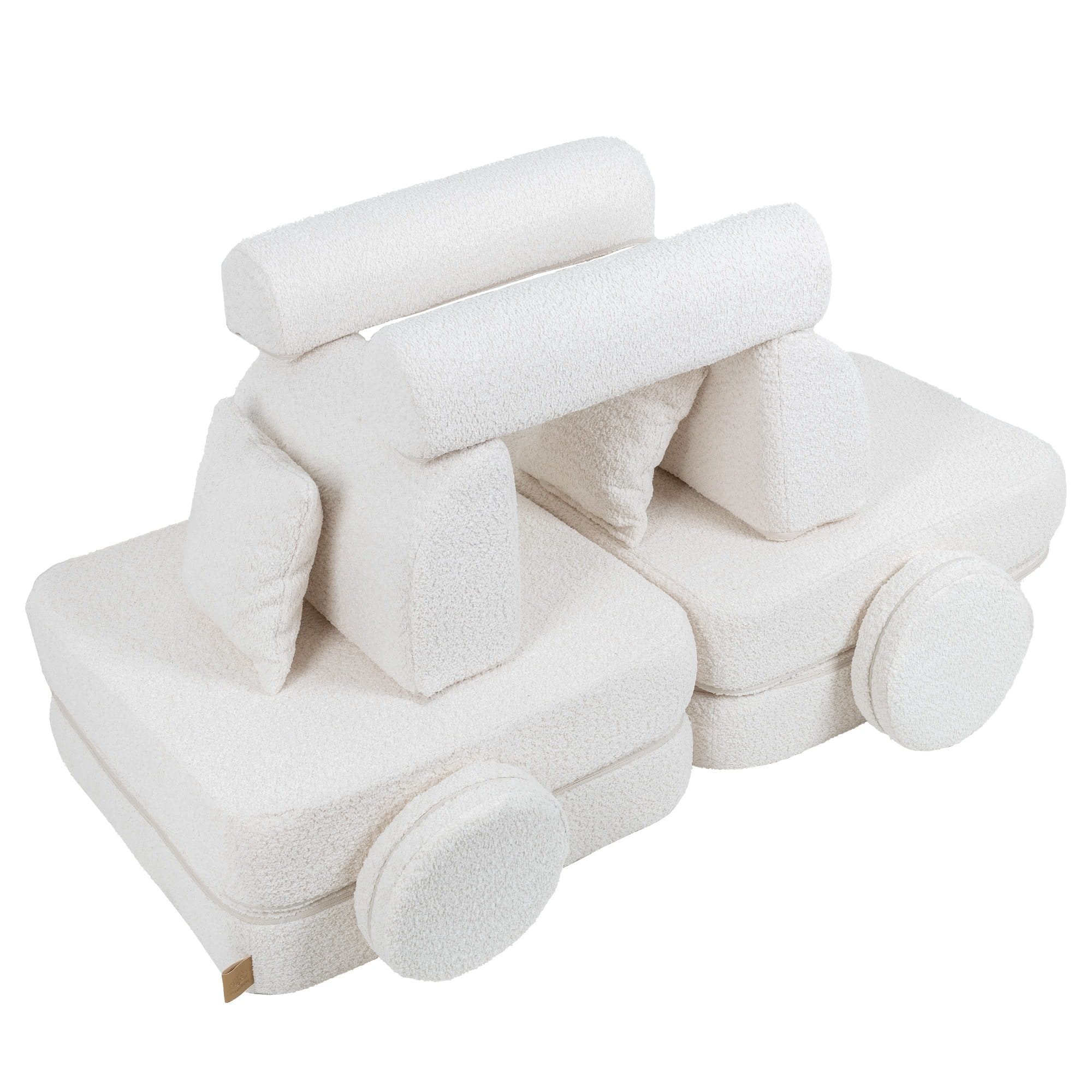 2. Medium modular children's sofa in white boucle fabric arranged creatively with cushions forming a playful structure