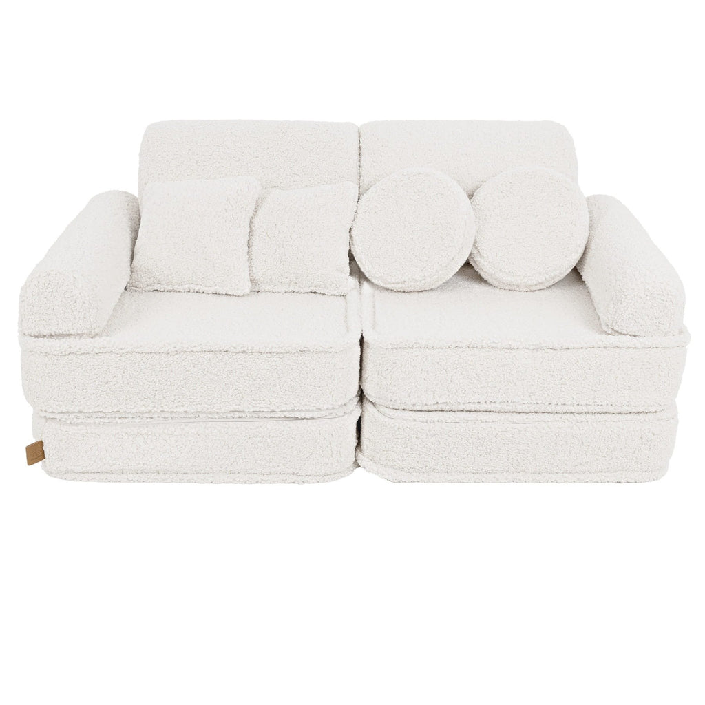 1. Medium modular sofa for kids in bearly cream with two square and two round cushions, shown in a studio setting.