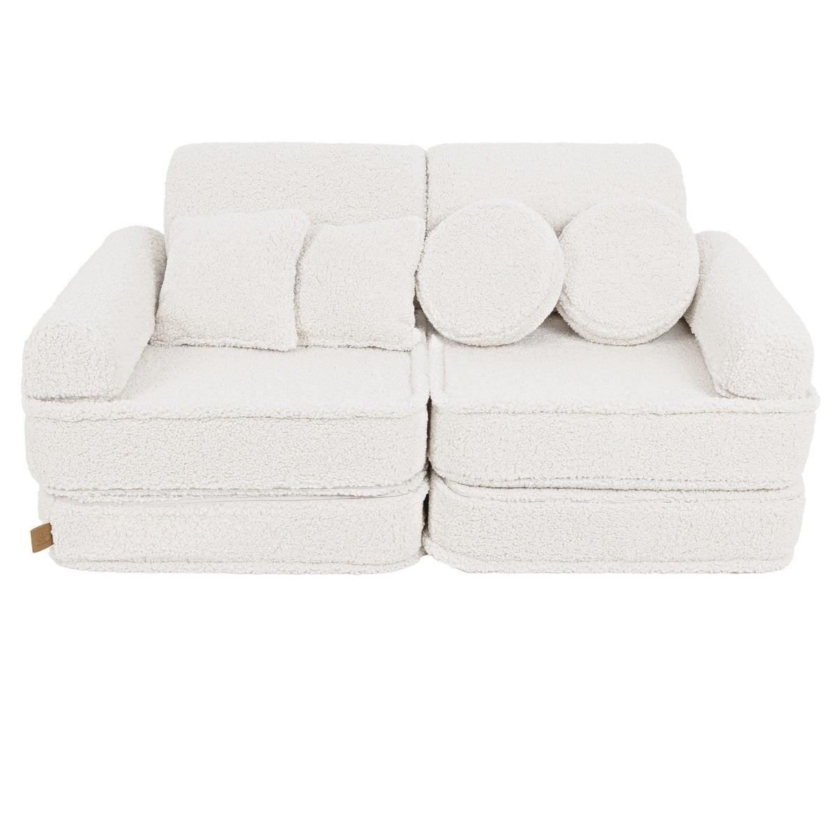 1. Medium modular sofa for kids in bearly cream with two square and two round cushions, shown in a studio setting.