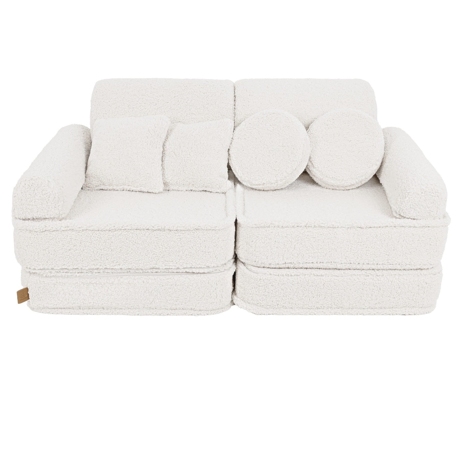 1. Medium modular sofa for kids in bearly cream with two square and two round cushions, shown in a studio setting.