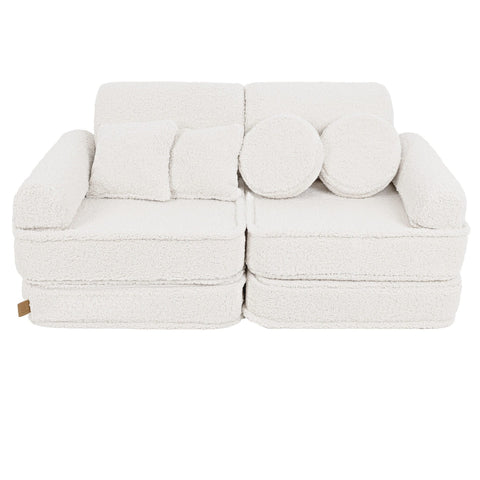 1. Medium modular sofa for kids in bearly cream with two square and two round cushions, shown in a studio setting.