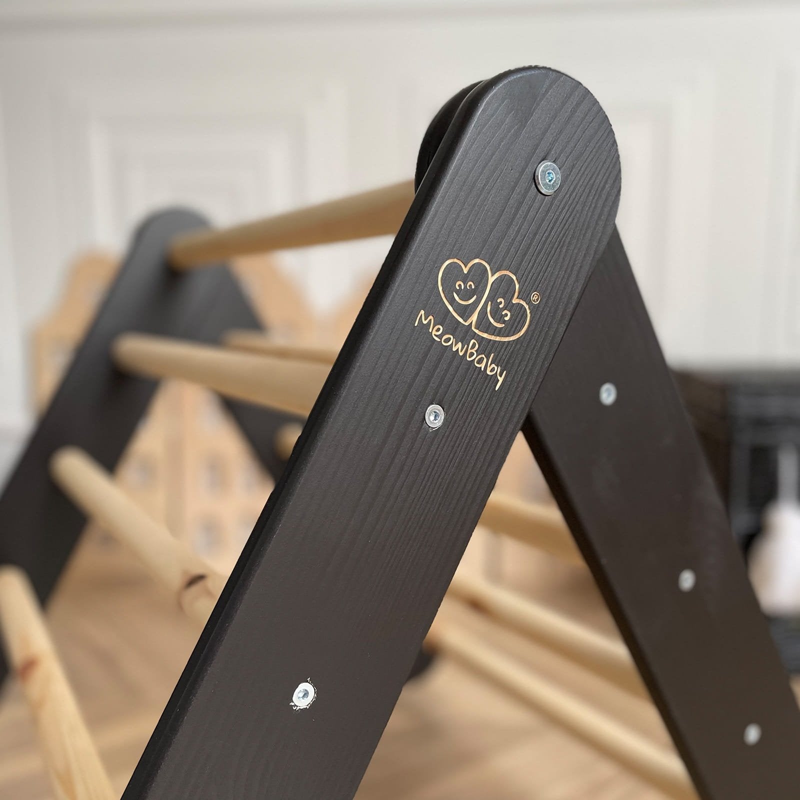 3. Close-up of MeowBaby logo on black wooden frame of children's ladder house