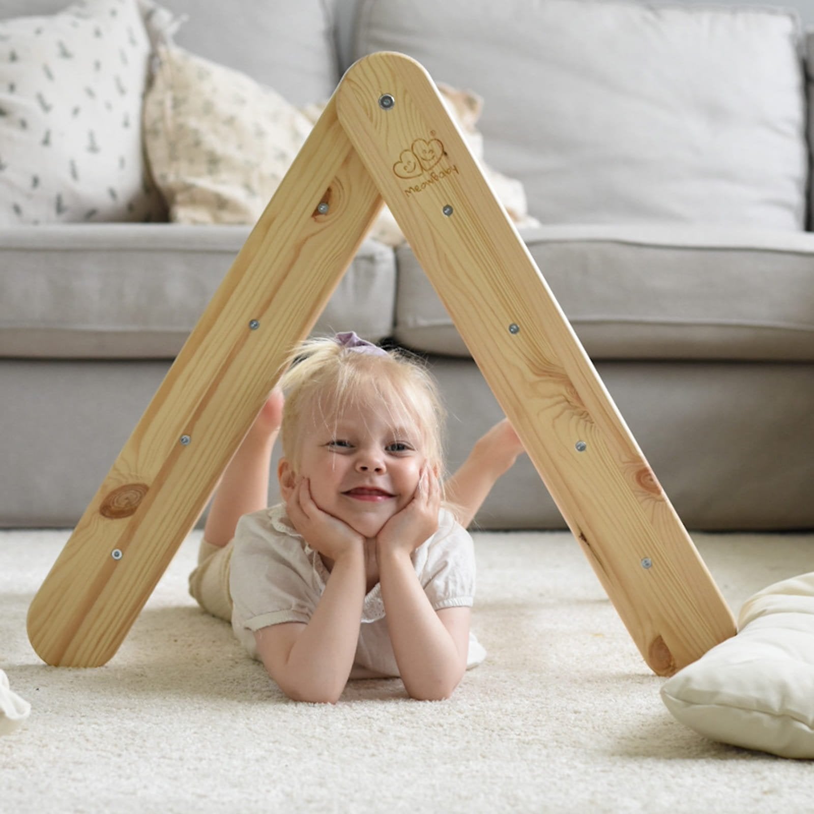 13. Child lying under natural wood ladder house in living room setting