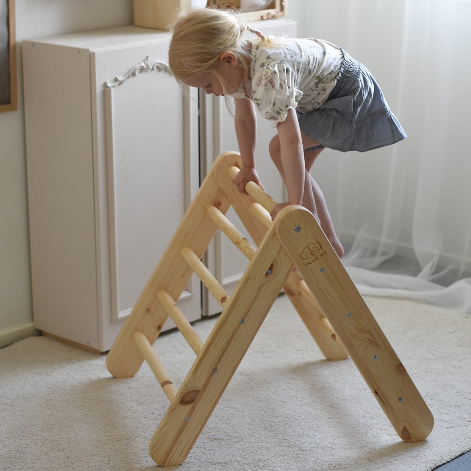 10. Child climbing natural wood ladder house in a room setting