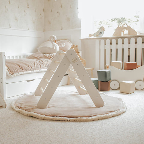 2. White ladder house in children's room with soft lighting and plush decor