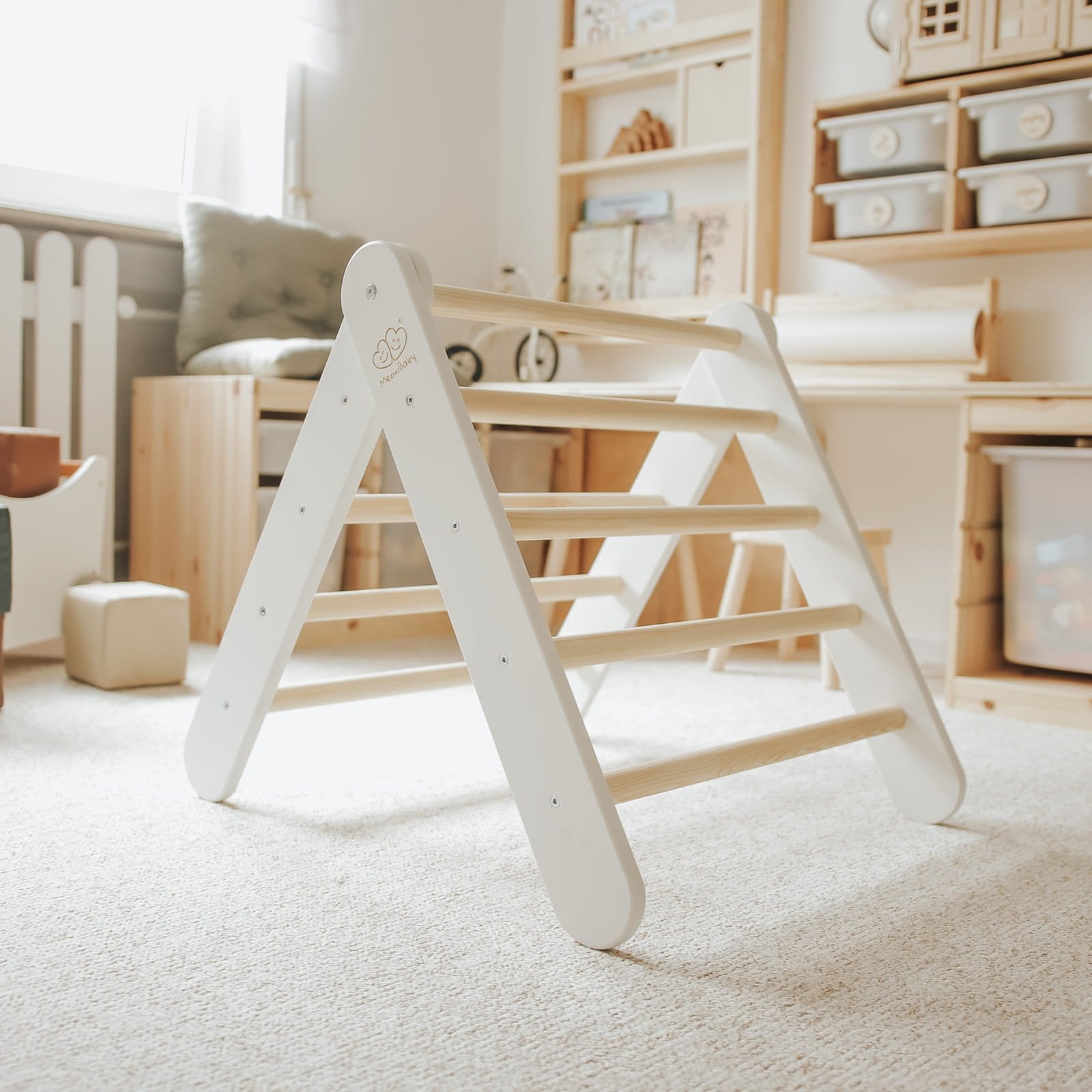 5. White ladder house in bright playroom with wooden shelves and toys