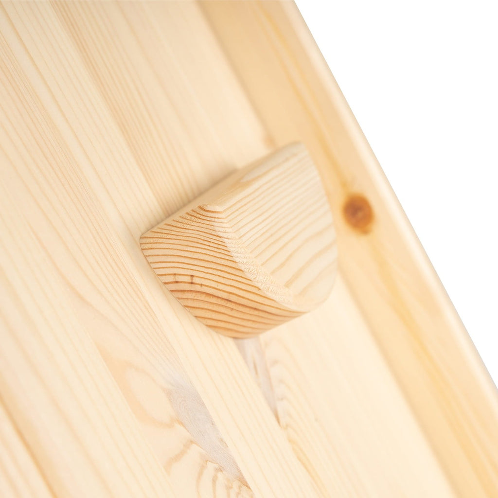 6. Close-up of rounded wooden grip on climbing wall, highlighting natural wood texture