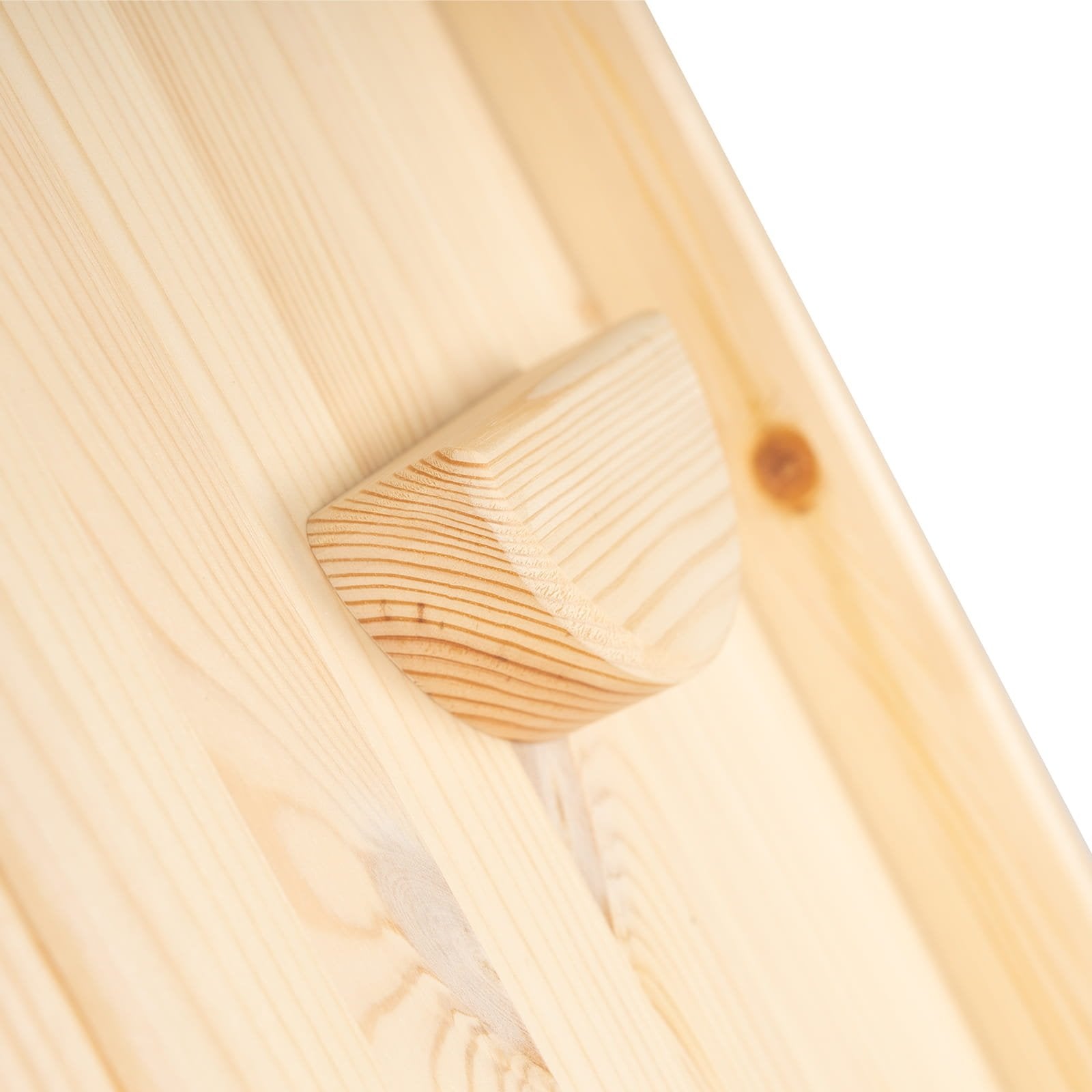6. Close-up of rounded wooden grip on climbing wall, highlighting natural wood texture