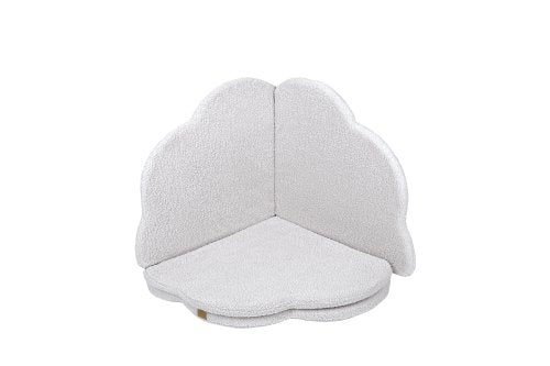 2. Cloud-shaped play mat in bearly white color, folded in a corner position with a textured surface, on a black background