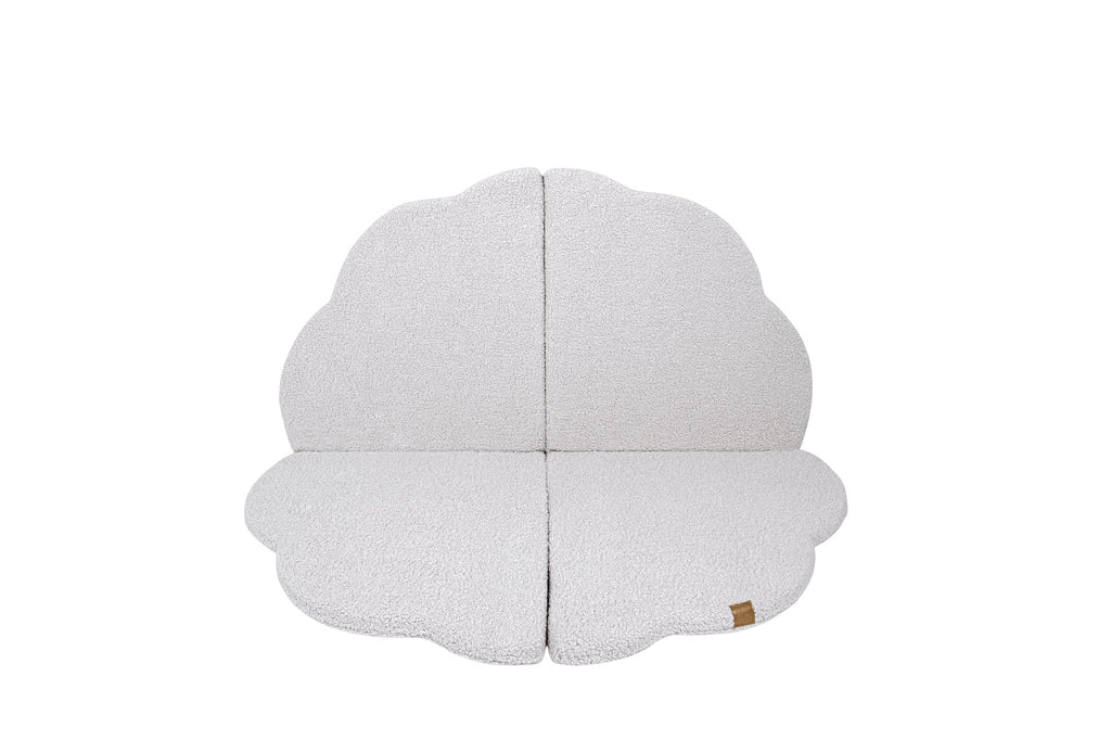 1. Cloud-shaped play mat in bearly white color, shown flat with a textured surface and a small brand tag, on a black background