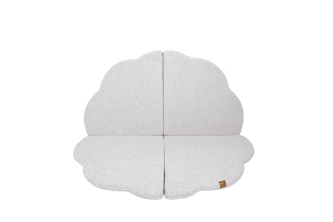 1. Cloud-shaped play mat in bearly white color, shown flat with a textured surface and a small brand tag, on a black background
