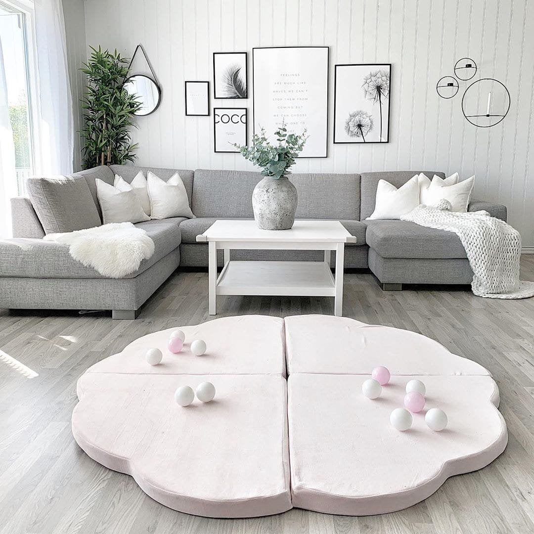 6. Pink cloud-shaped velvet play mat with balls in a modern living room setting
