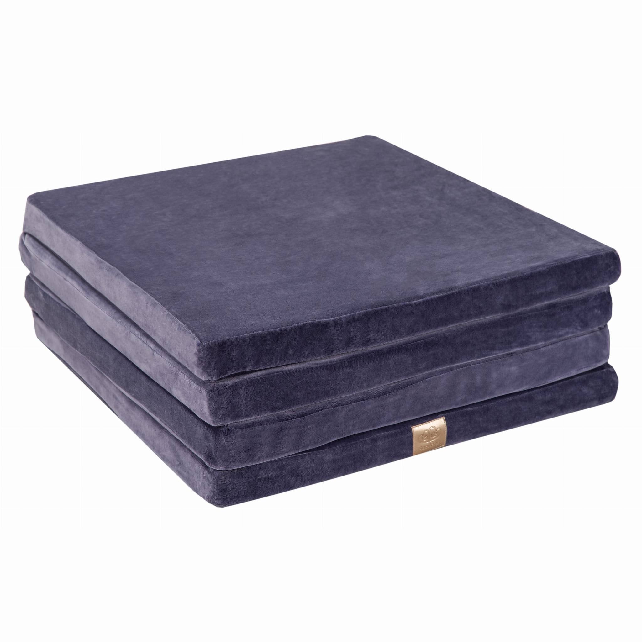 7. Folded stack of square blue-grey velvet play mat on a white background