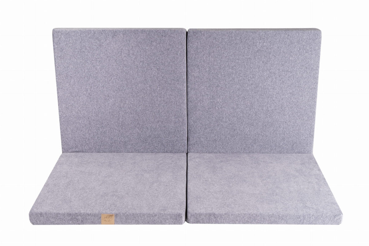 2. Square light grey velvet play mat partially folded on a white background