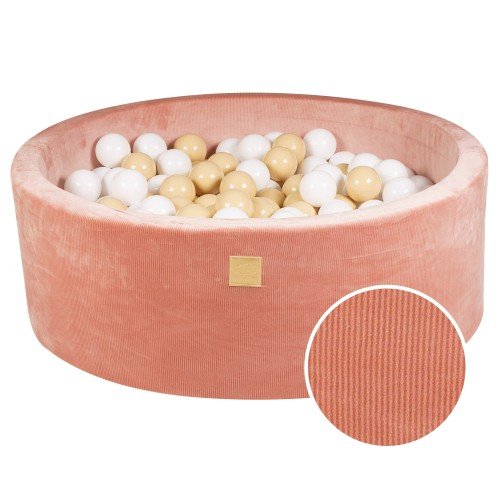 1. Apricot velvet round ball pit filled with sand and white balls, featuring soft hypoallergenic foam and machine washable cover, ideal for children's sensory play and motor skill development