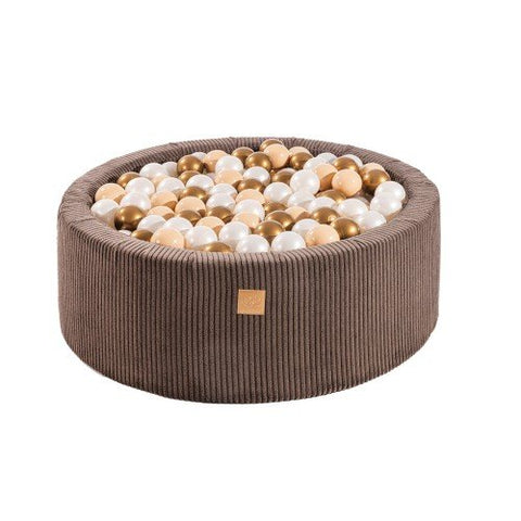 1. Aesthetic brown round ball pit filled with 200 white and copper balls, made from soft hypoallergenic foam, featuring a zippered cover, ideal for children's sensory play and motor skill development.