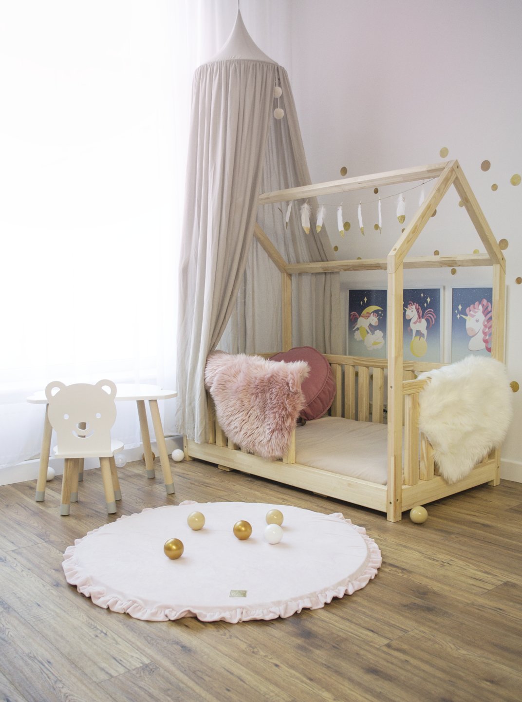 1. Pink round play mat with frill in a cozy children's room with wooden bed and decor