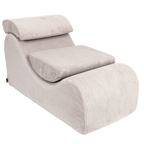 1. Ecru wave lounger with ergonomic headrest and footrest in ribbed fabric, shown in a studio setting
