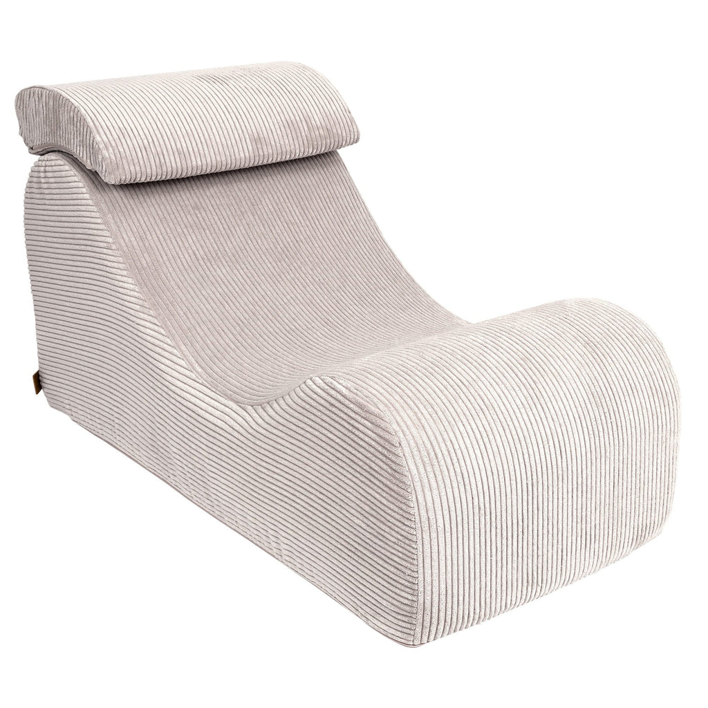 8. Ecru wave lounger with ergonomic headrest in ribbed fabric, shown in a studio setting