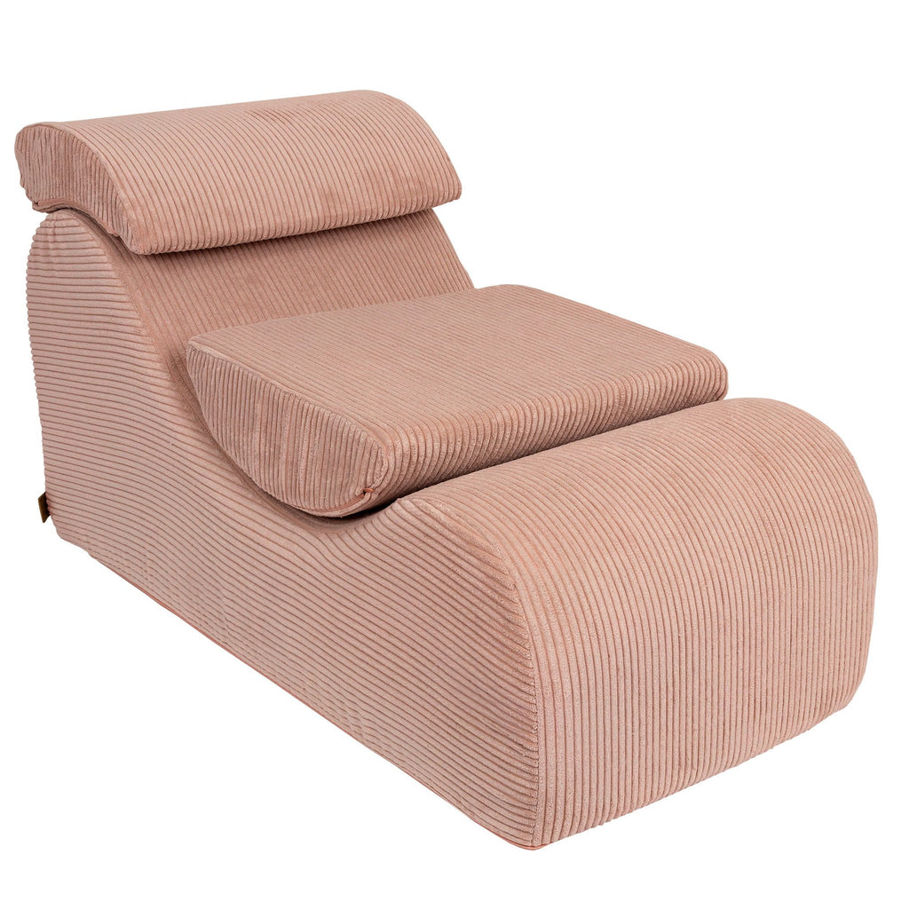 1. Powder rose wave lounger with ergonomic headrest and footrest in studio setting