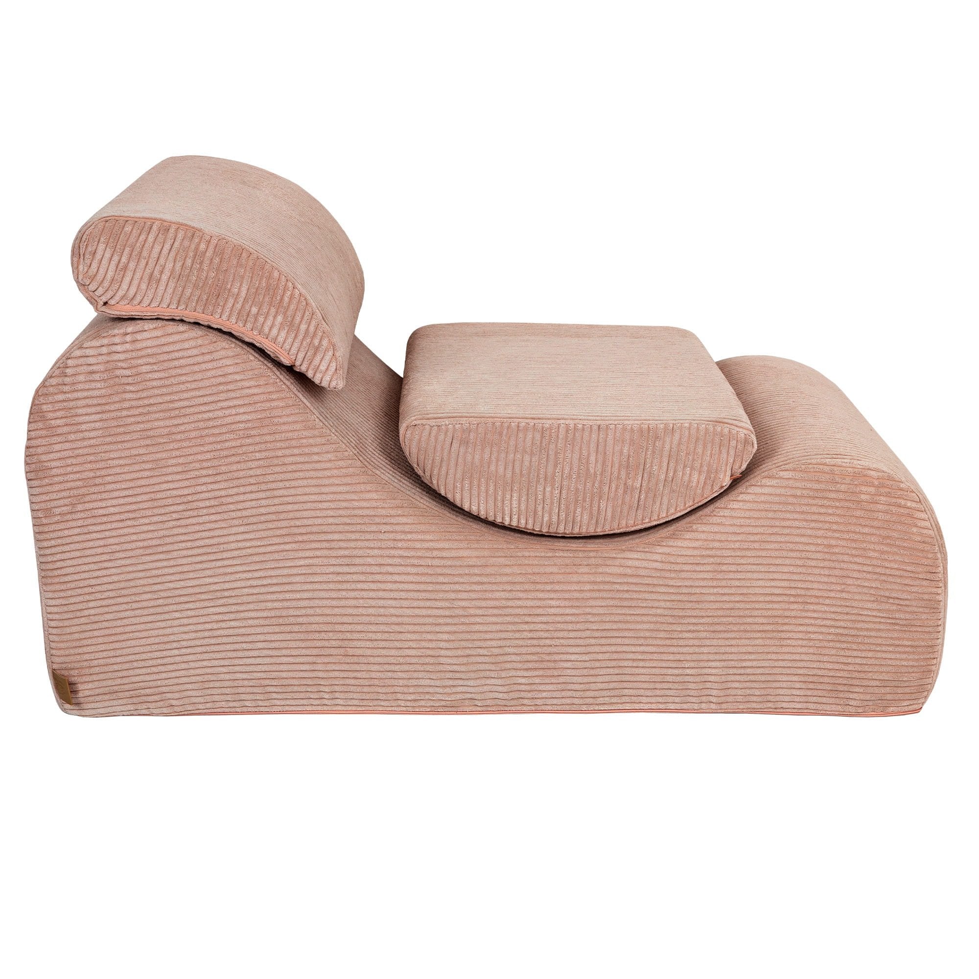 4. Side view of powder rose wave lounger with ergonomic headrest and footrest in studio setting