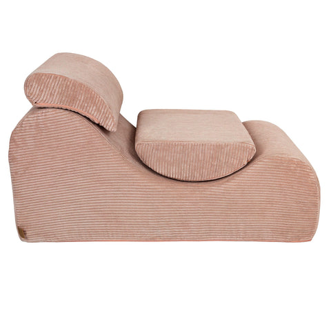 4. Side view of powder rose wave lounger with ergonomic headrest and footrest in studio setting