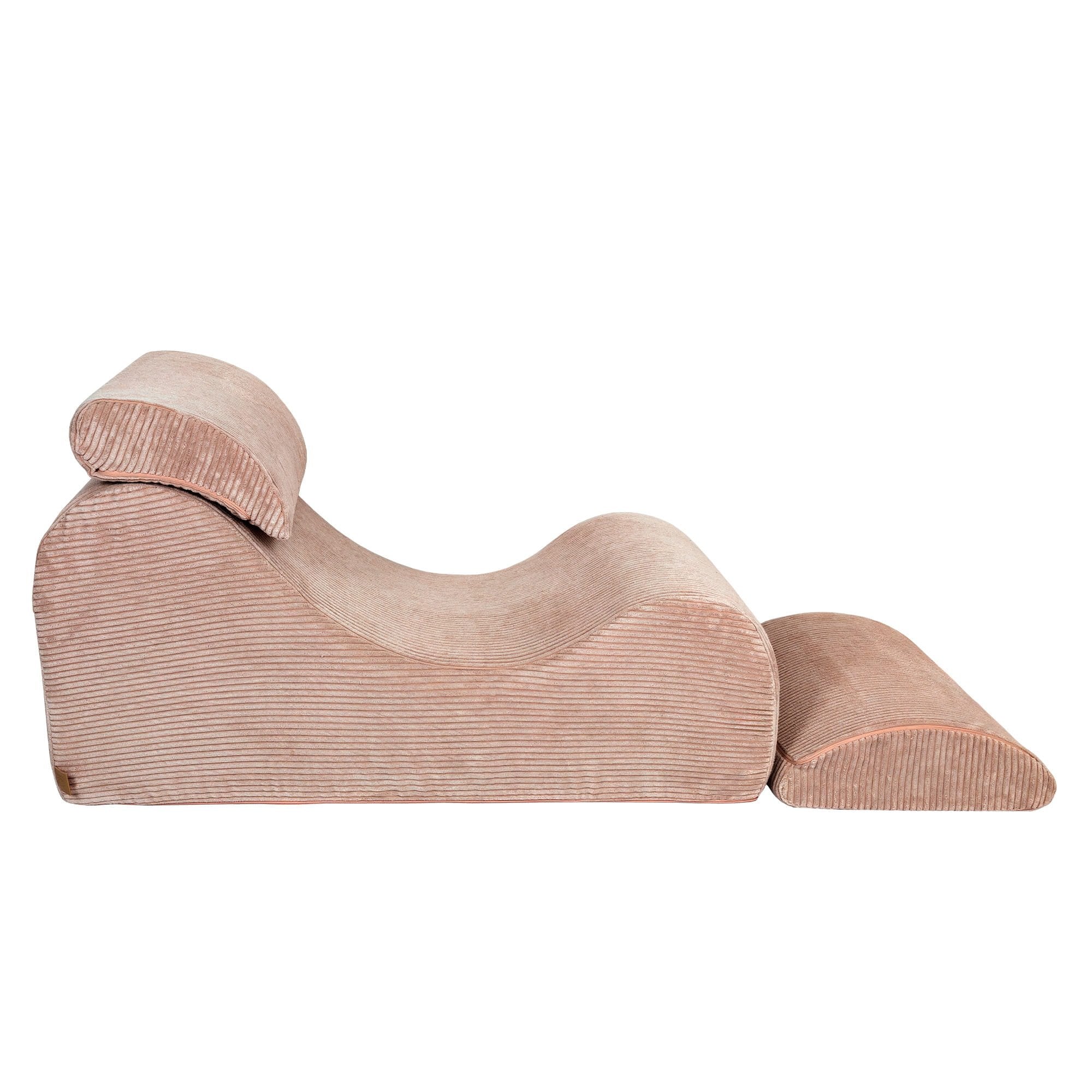 7. Side view of powder rose wave lounger with extended footrest and ergonomic headrest in studio setting