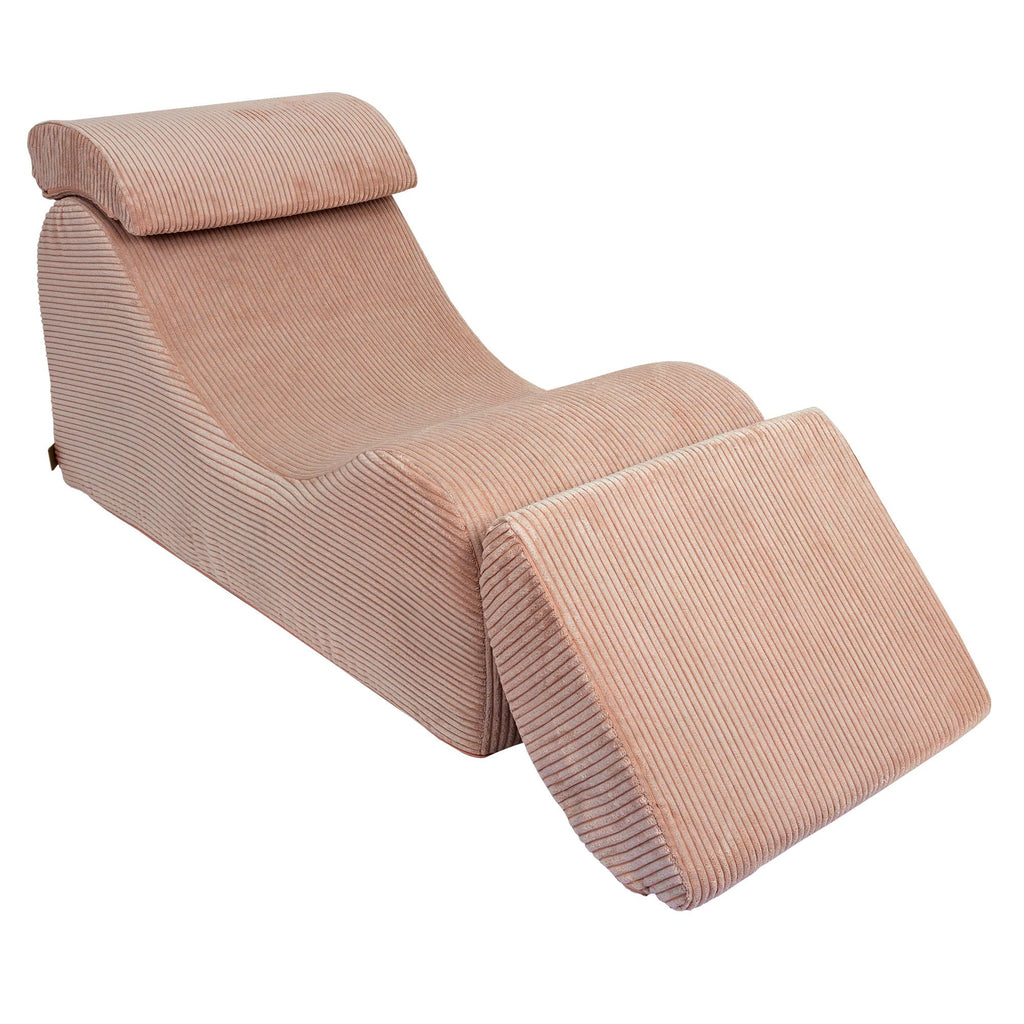 2. Powder rose wave lounger with extended footrest and ergonomic headrest in studio setting