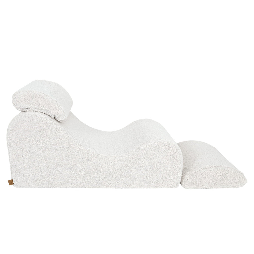 4. Side profile of cream Wave Lounger with extended footrest, showcasing its S-shaped design