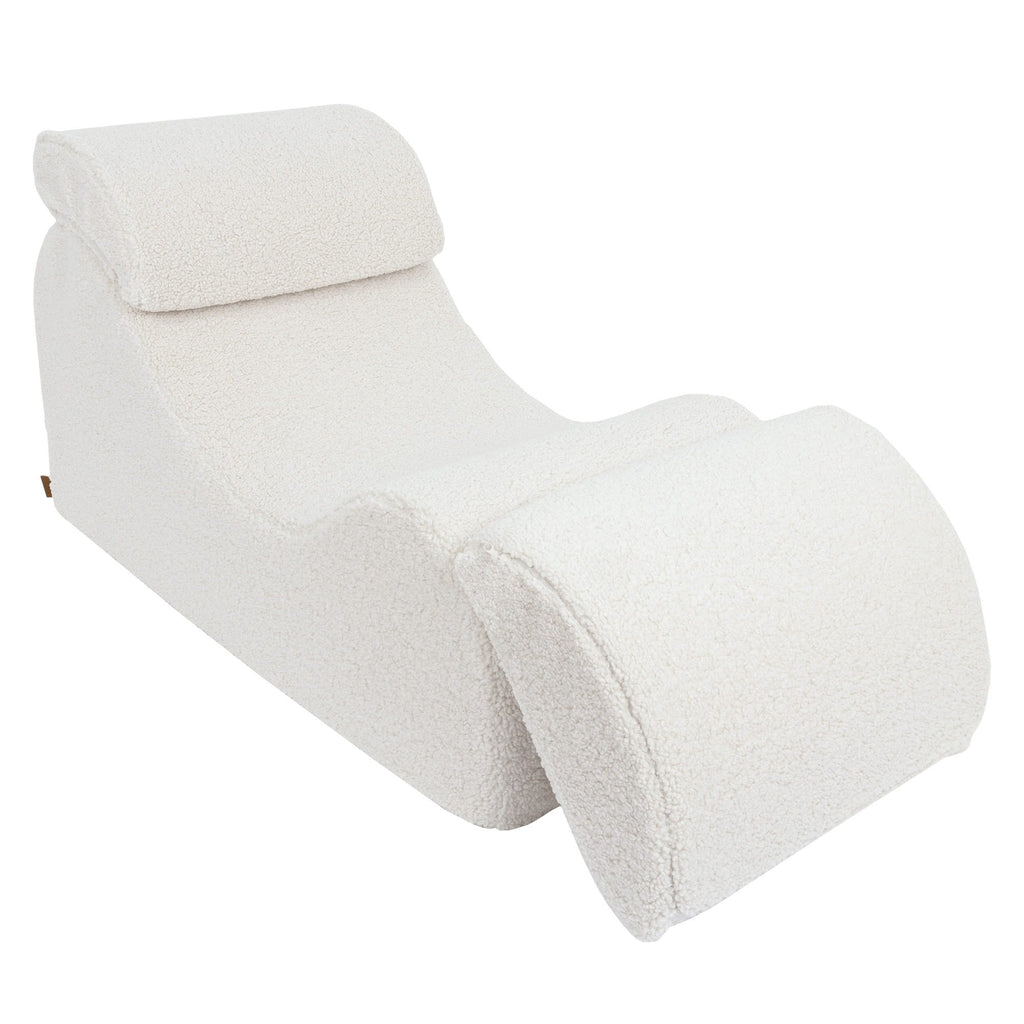 2. Cream Wave Lounger with extended footrest and contoured shape, displayed in a studio