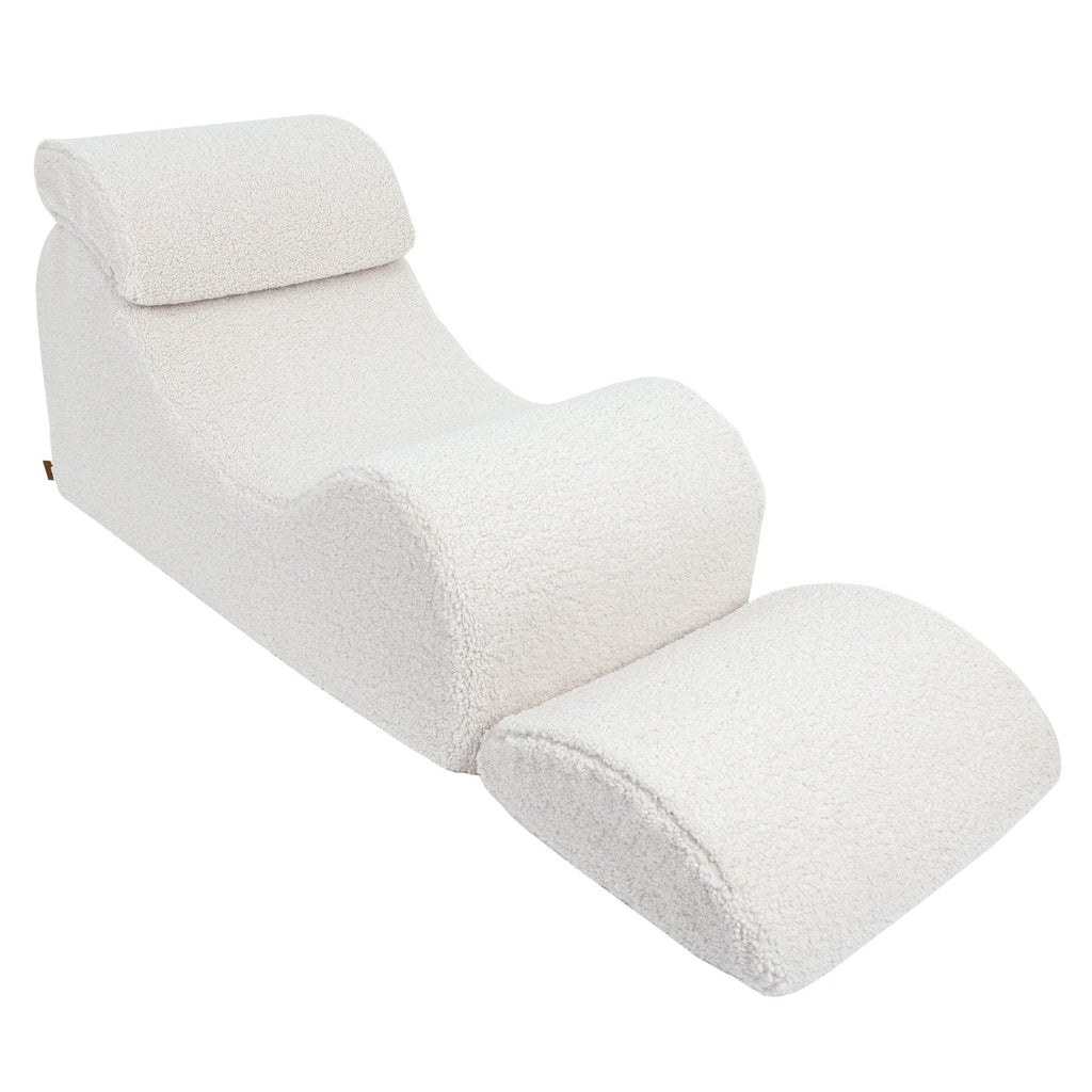 3. Side view of cream Wave Lounger with extended footrest, highlighting its ergonomic design