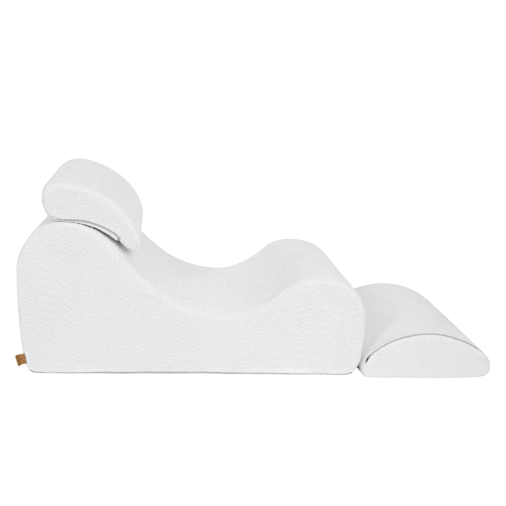 7. White boucle Wave Lounger with fully extended footrest, shown from a side view to emphasize its ergonomic design