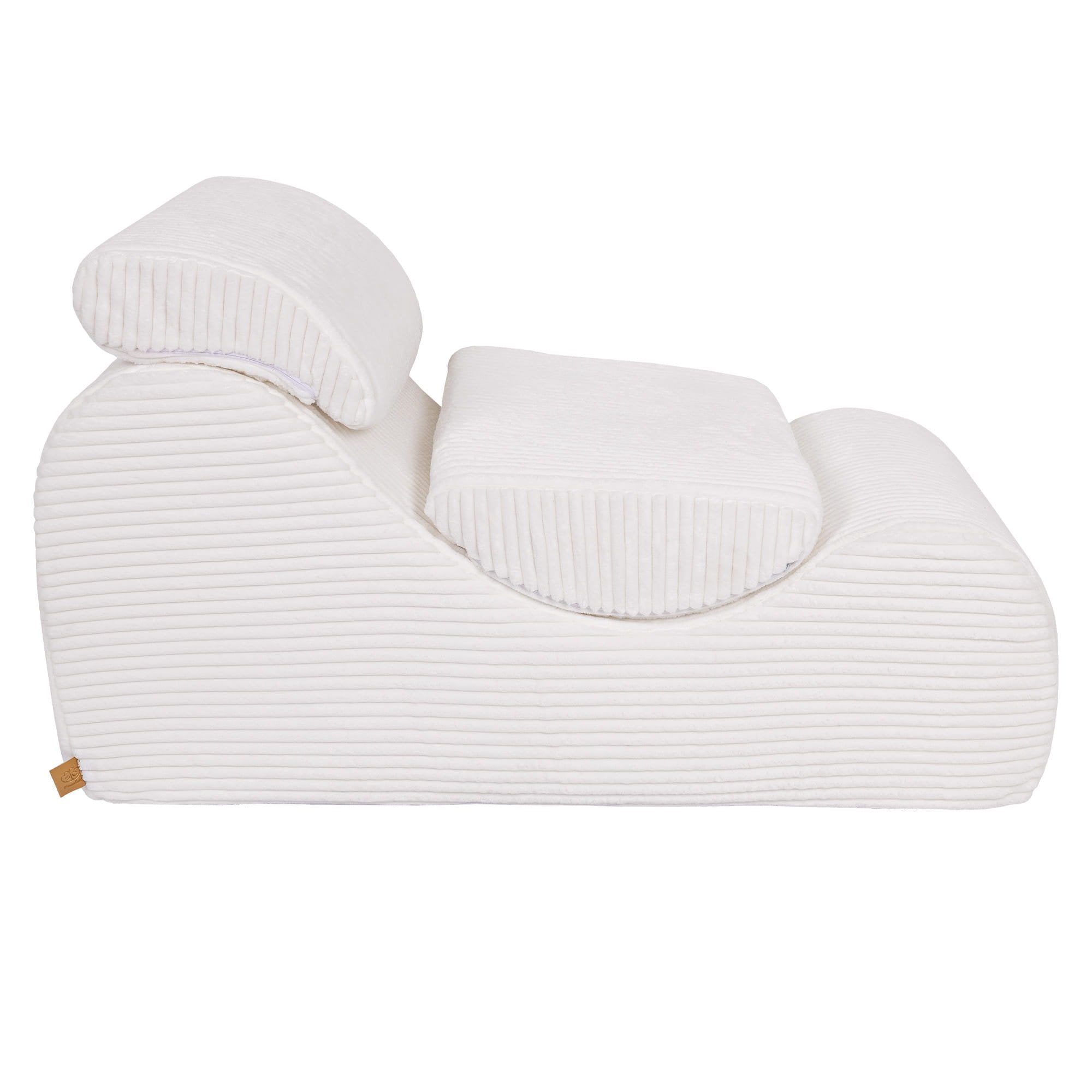 8. Side view of white furrycord Wave Lounger with headrest and footrest, emphasizing design