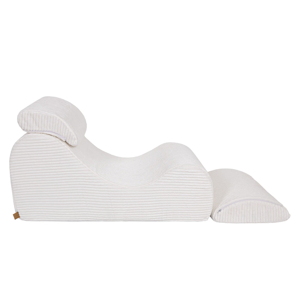 2. Side view of white furrycord Wave Lounger with distinctive S shape and removable headrest