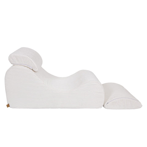 2. Side view of white furrycord Wave Lounger with distinctive S shape and removable headrest