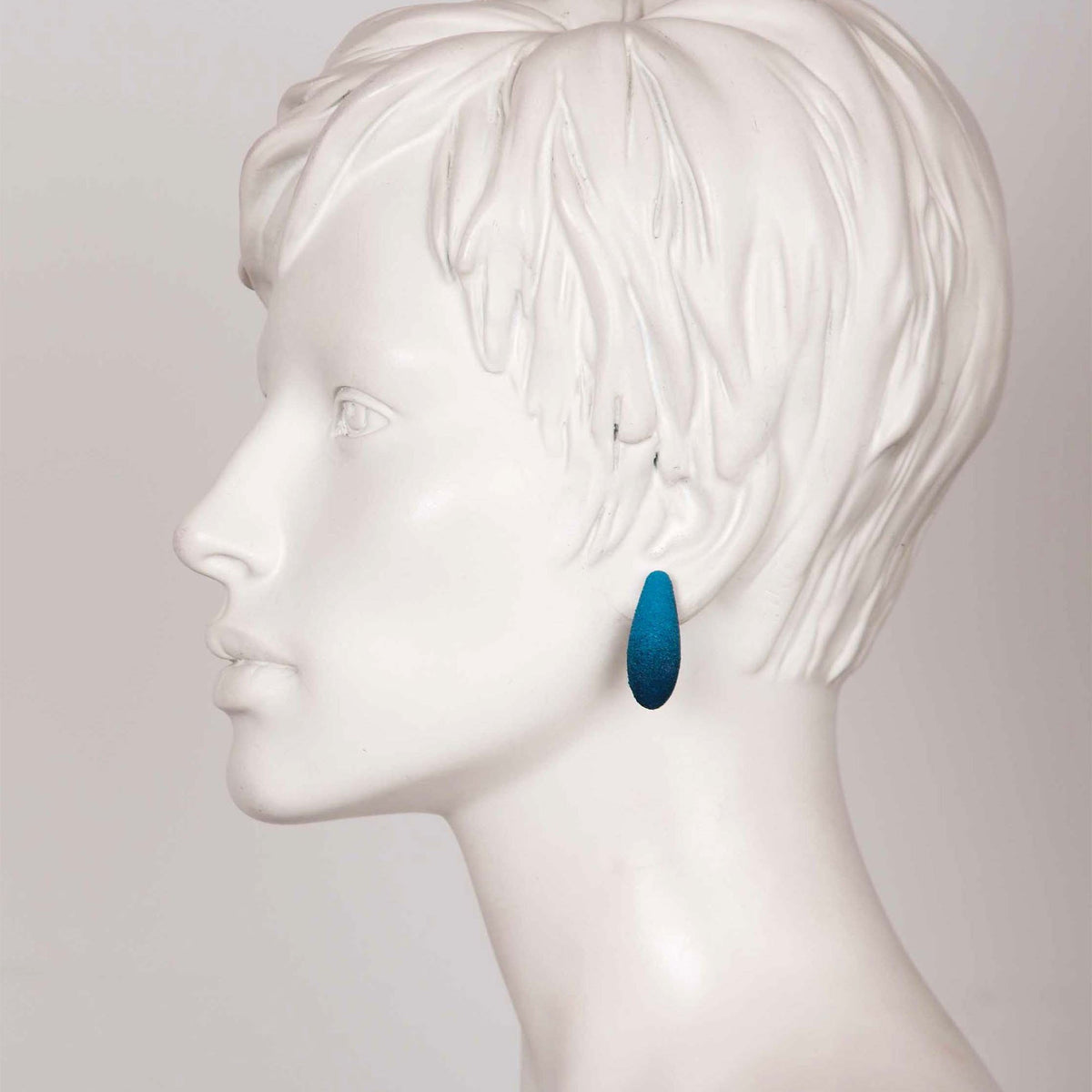 1. Blue Mini Gooseberries earring by Tanel Veenre worn on mannequin head, showcasing elegant drop design