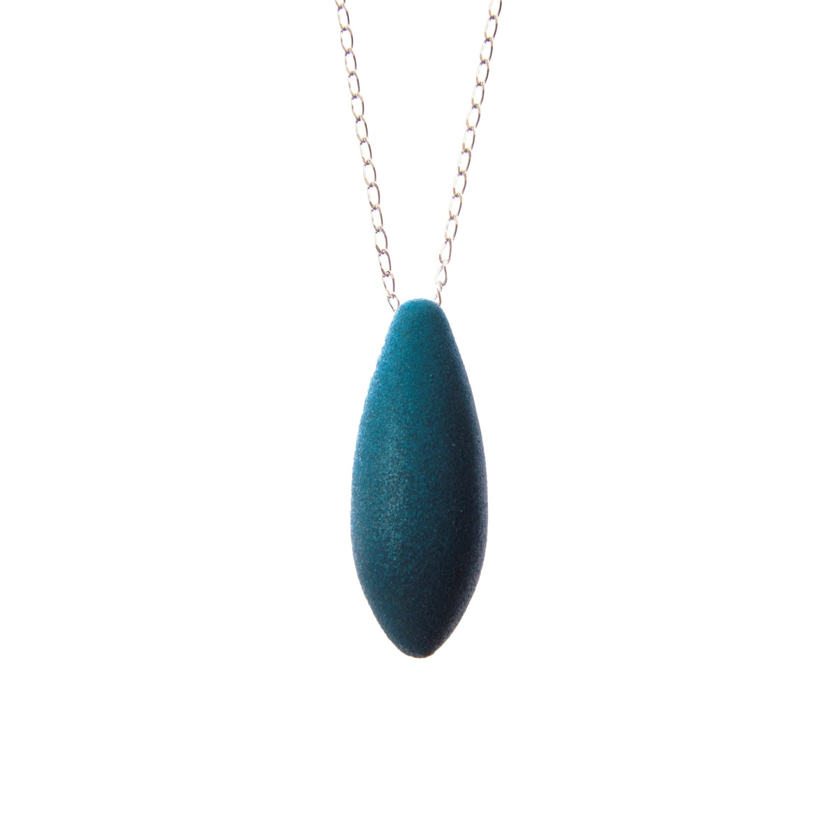2. Tanel Veenre Mini Gooseberry Pendant with teal velvety coating on silver chain, shown in studio lighting highlighting its unique cosmic dust texture