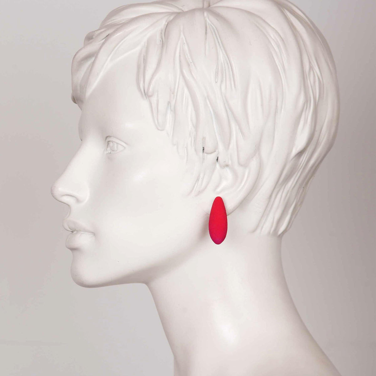 1. Side profile of mannequin wearing Tanel Veenre Mini Raspberries Earring in red, showcasing size and fit