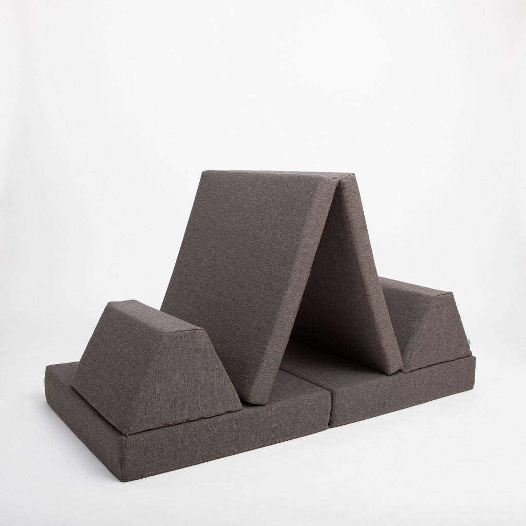 16. Monboxy dark brown play mattress set configured as a tent in a studio