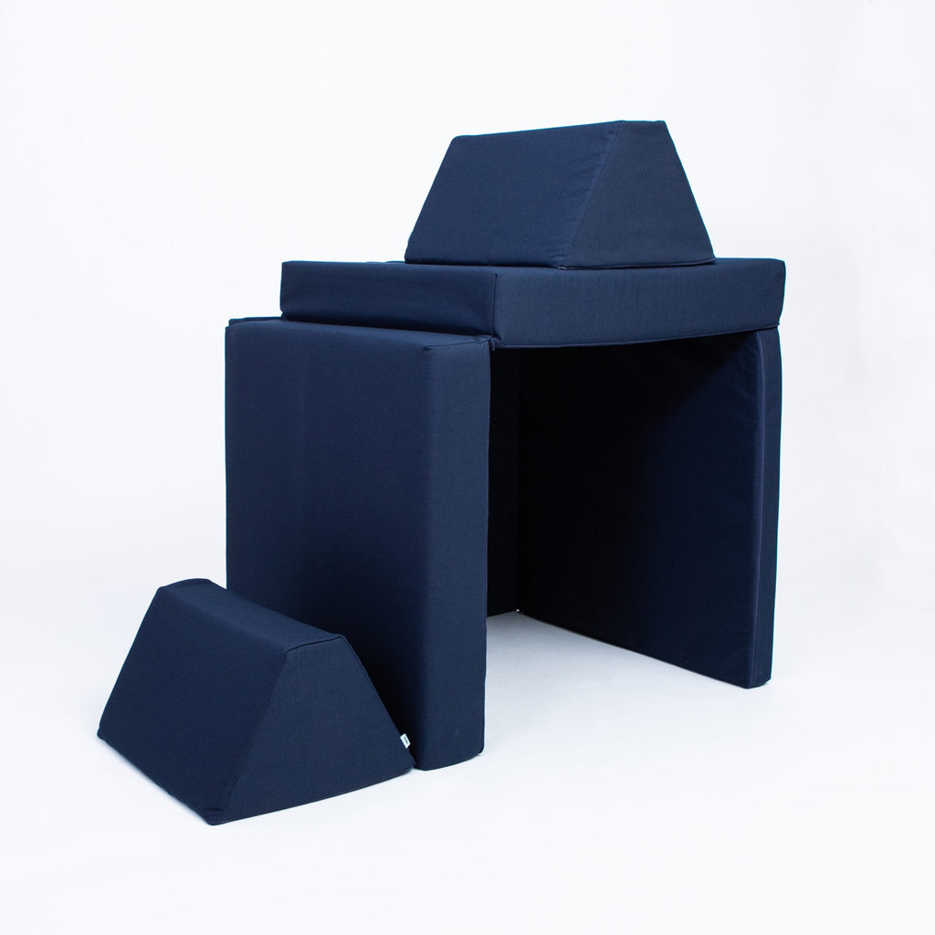 2. Navy blue play mattress set configured as a fort with trapezoidal pillows on a white background