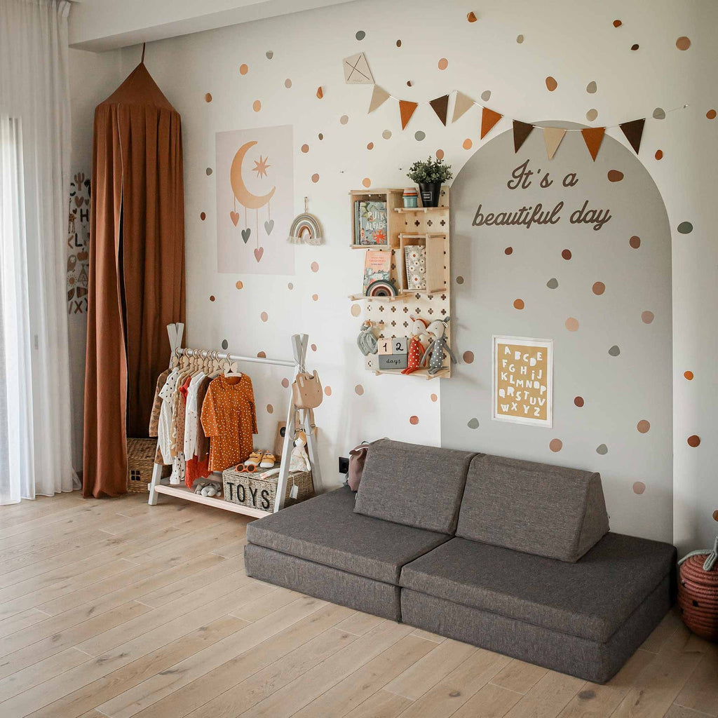 4. Monboxy dark brown play mattress set arranged as a sofa in a colorful children's room